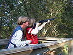 Coach Addie helping Heather smoke a target.